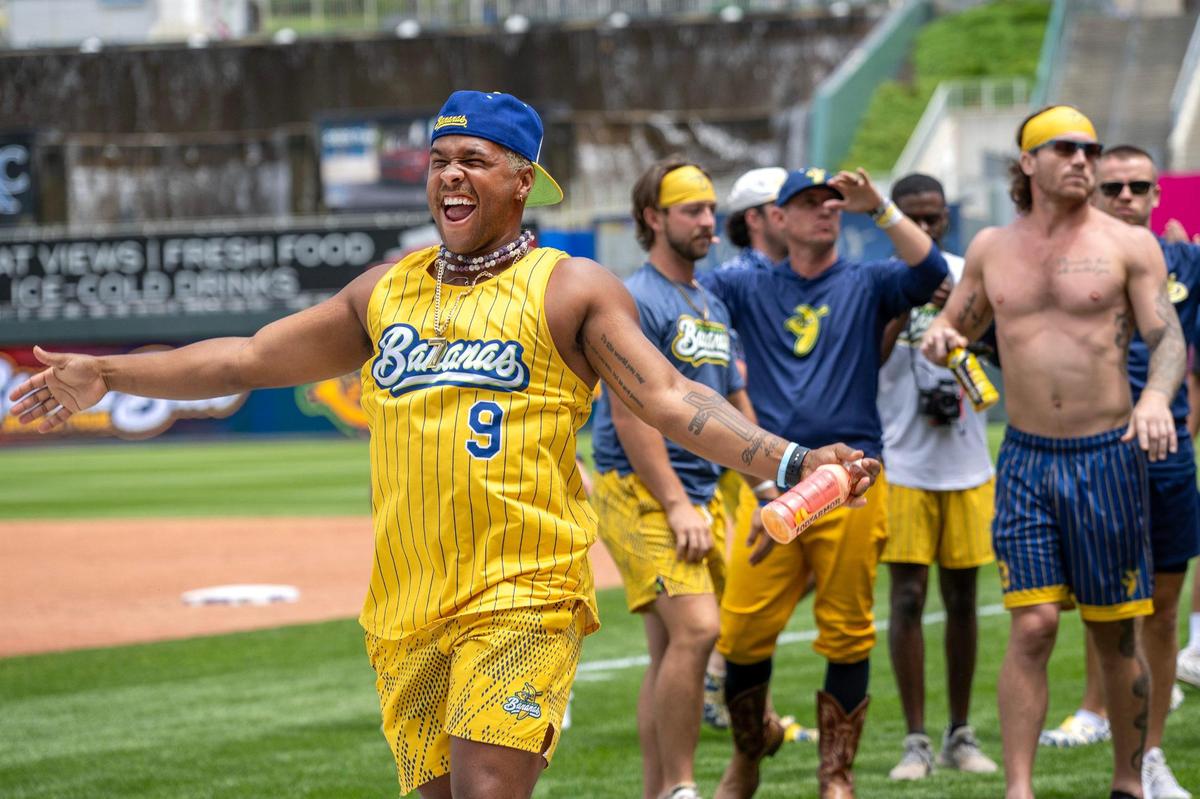 Savannah Bananas outfielder Ty Jackson (7) shimmies while practicing a dance routine with teammates before a Banana Ball game against the Firefighters at Kauffman Stadium on Friday, May 23, 2025, in Kansas City.