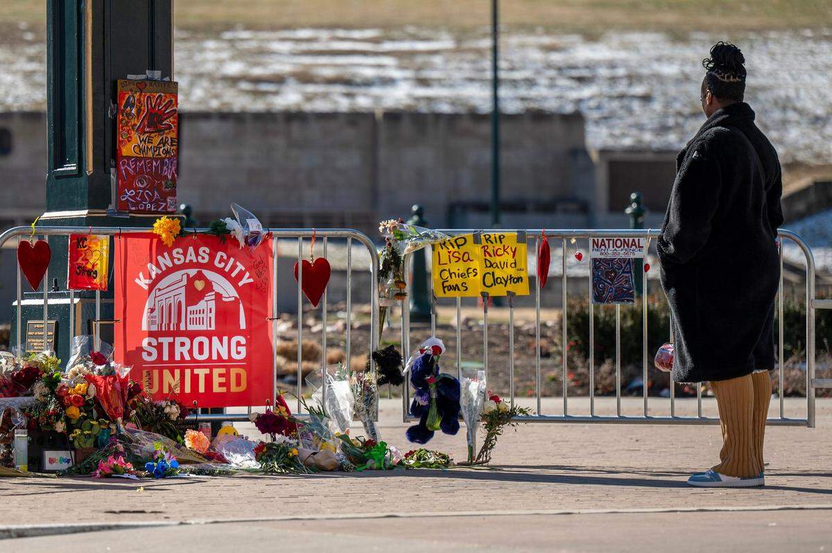 In this Feb. 18 photo a visitor takes a moment to look at a makeshift memorial at Union Station four days after a mass shooting left one person dead and more than 20 injured after the Kansas City Chiefs’ Super Bowl victory rally.