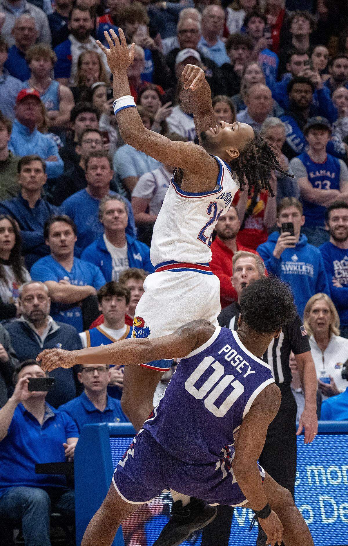 TCU Horned Frogs forward Jace Posey (00) fouls Kansas Jayhawks guard Darryn Peterson (22) on a 3-point shot late in the second half at Allen Fieldhouse in Lawrence on Tuesday, Jan. 6, 2025. The three free throws from the foul sent the game into overtime.