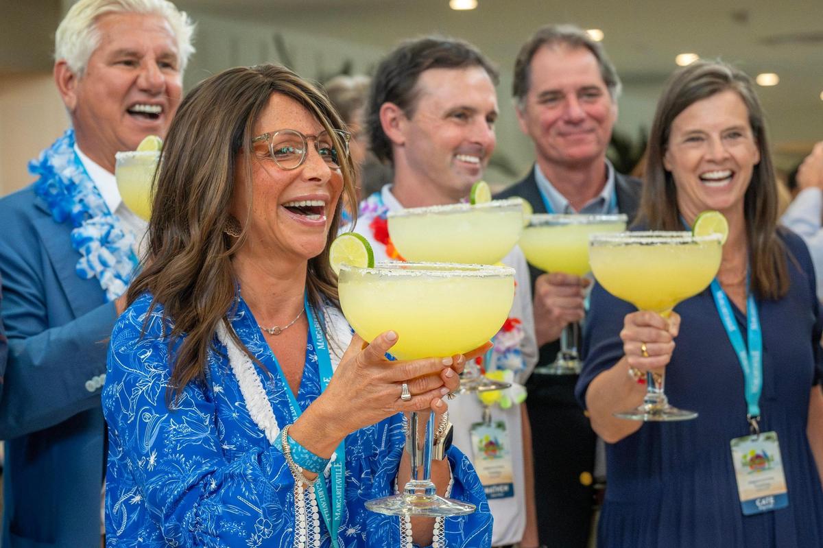 Tamera Baldanza-Dekker, chief marketing officer of Margaritaville Hotel, toasts with a margarita goblet during the ribbon-cutting ceremony for Margaritaville Hotel on Tuesday, June 17, 2025, in Kansas City, Kansas.