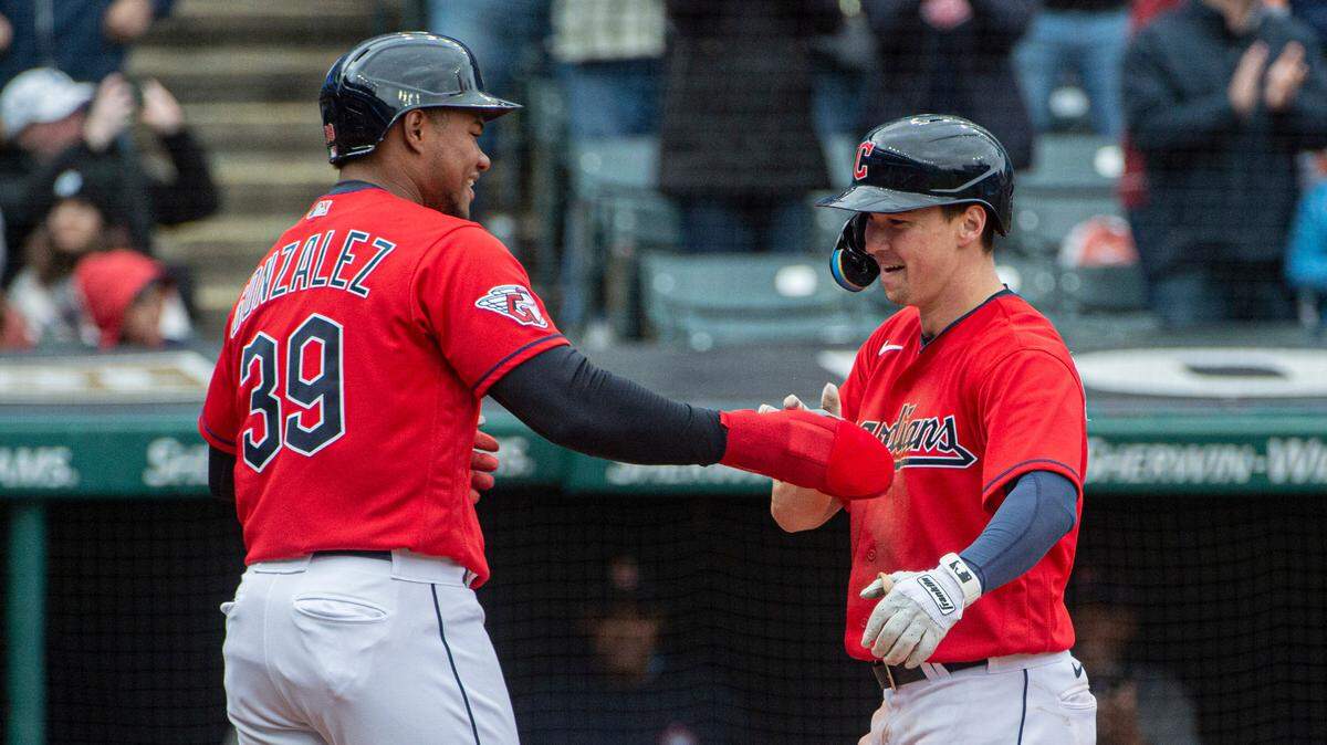 Cleveland Guardians’ Will Brennan (right) is congratulated by Oscar Gonzalez after Brennan hit a three-run home run off Kansas City Royals starting pitcher Max Castillo during the second inning in Cleveland, Sunday, Oct. 2, 2022.