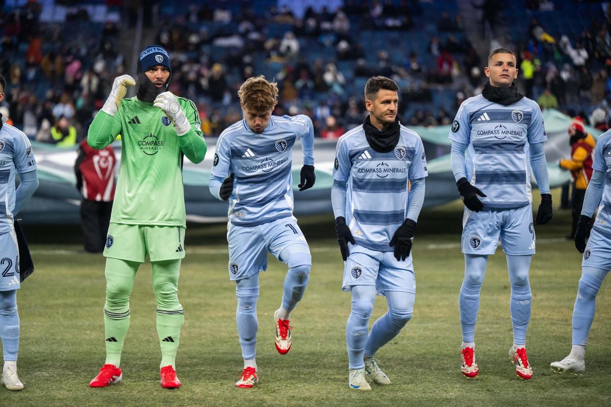 Sporting KC players attempt to stay warm for the beginning of the Concacaf Champions Cup match of Sporting KC vs. Inter Miami CF on Wednesday, Feb. 19, 2025, at Sporting Park. The temperatures were in the single digits for the game that Sporting KC lost to Miami 0-1.