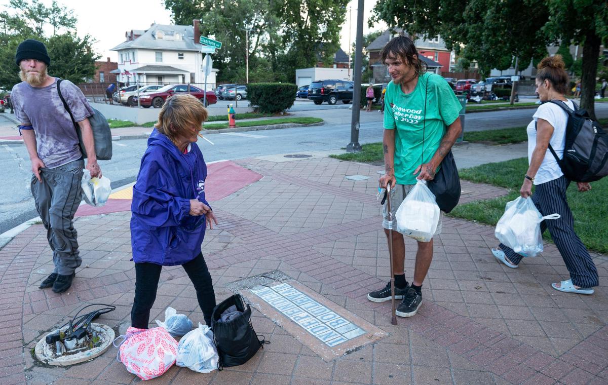 Josephine Kelly Crothers, center left, talks with Chris Culp during Monday Night Church at the Independence Boulevard Christian Church. Culp goes to the church every Monday for food, clothing, and physical therapy with Care Beyond the Boulevard.