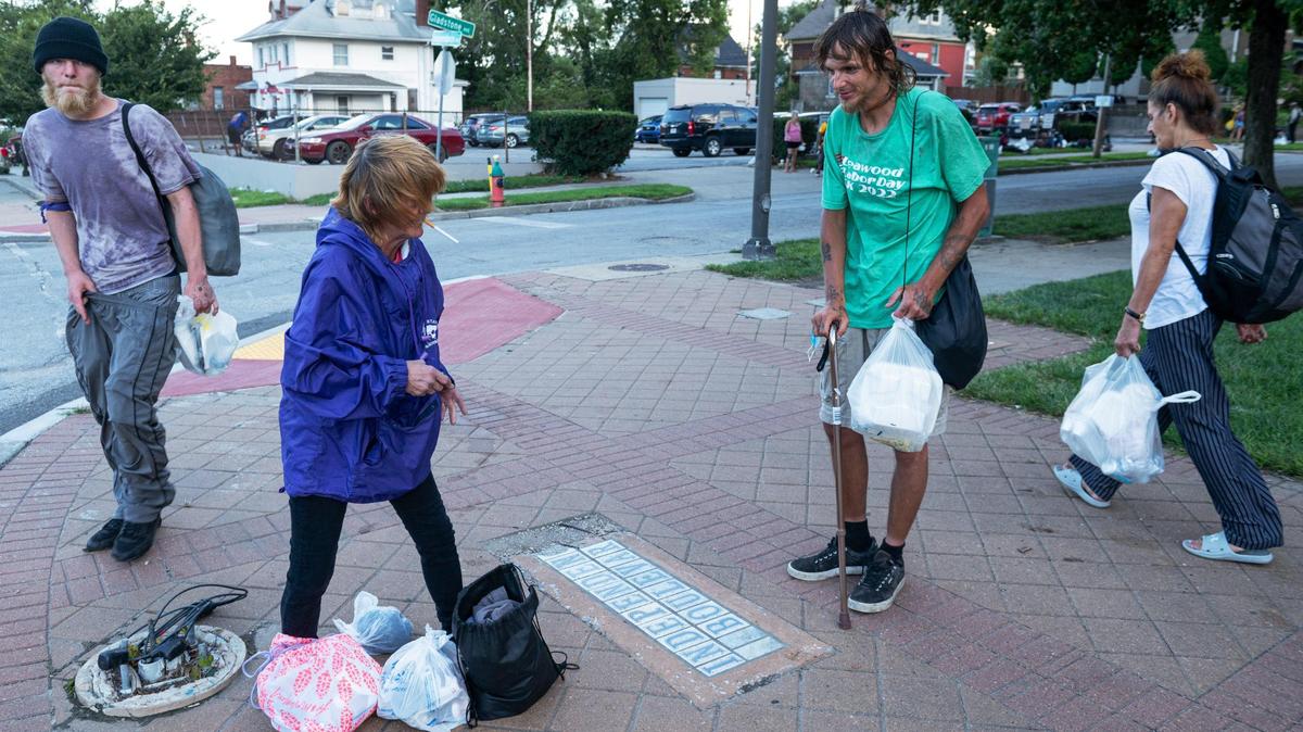 Josephine Kelly Crothers, center left, talks with Chris Culp during Monday Night Church on Monday, Aug. 14, 2023, at the Independence Boulevard Christian Church in Kansas City. Culp goes to the church every Monday for food, clothing, and physical therapy with Care Beyond the Boulevard.