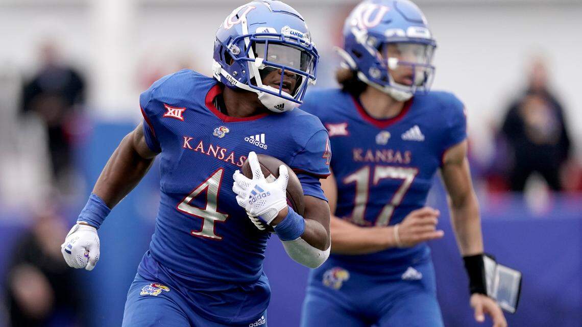 Kansas running back Devin Neal (4) runs the ball during the first half of an NCAA college football game against Oklahoma Saturday, Oct. 23, 2021, in Lawrence, Kan. (AP Photo/Charlie Riedel)