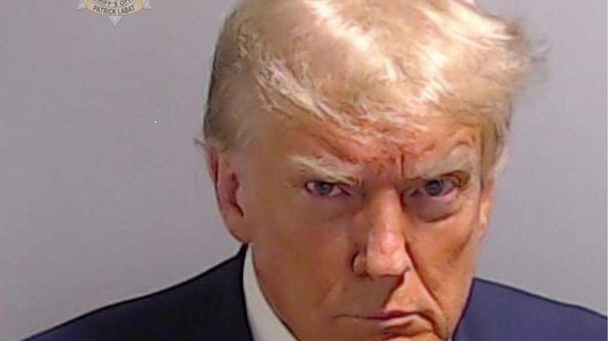 In a handout provided by the Fulton County Sheriff’s Office, former President Donald Trump poses for his booking photo at the Fulton County Jail on Thursday, Aug. 24, 2023, in Atlanta. Trump was booked on 13 charges related to an alleged plan to overturn the results of the 2020 presidential election in Georgia. (Fulton County Sheriff’s Office via Getty Images/TNS)