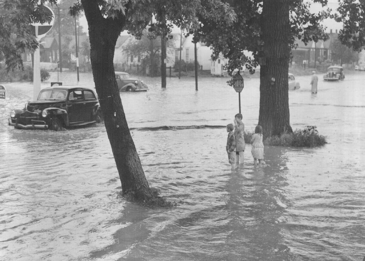 Children wade through flood water at 12th Street and Argentine Boulevard in Kansas City, Kan., July 1951.
