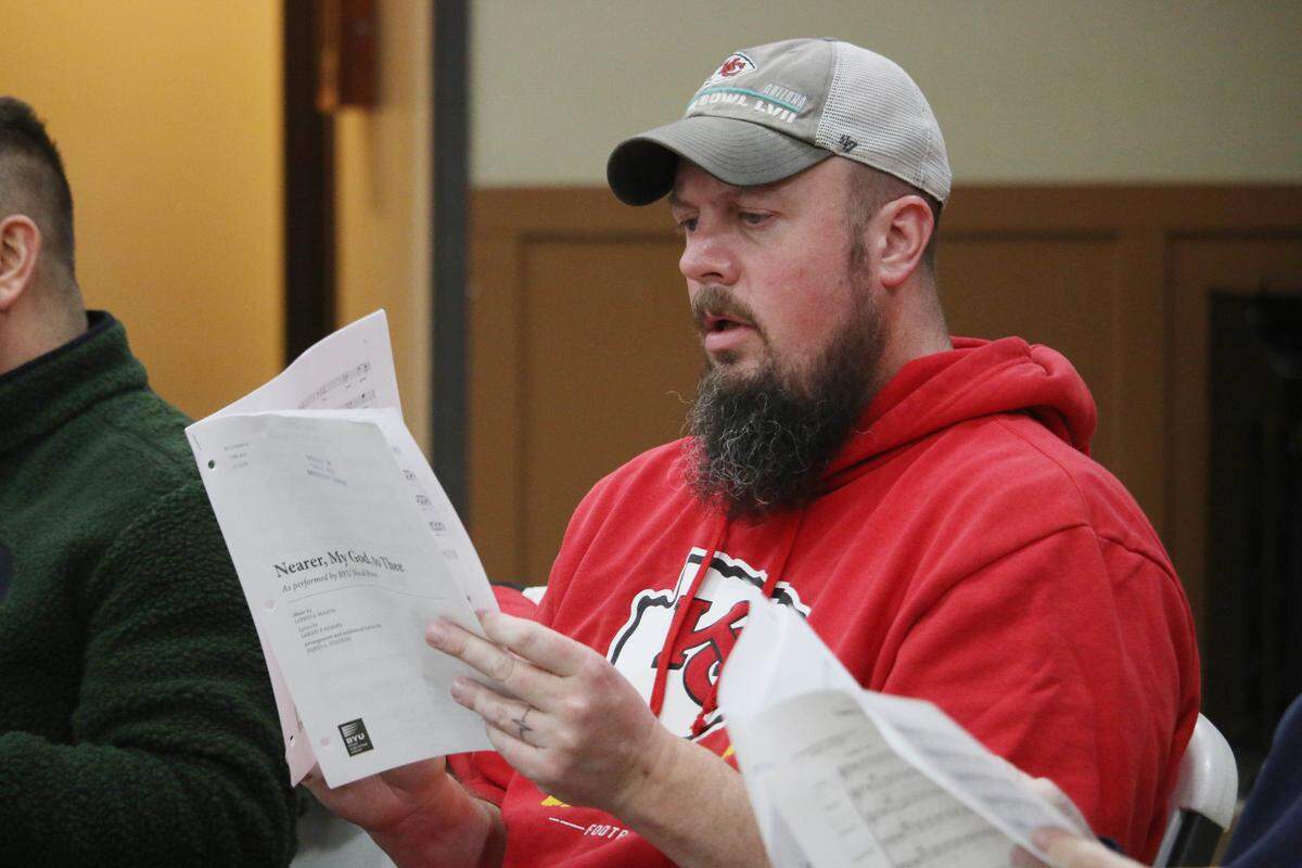 Tim McWilliams reads the music for ‘Nearer My God to Thee’ during a Trails West Chorus rehearsal.