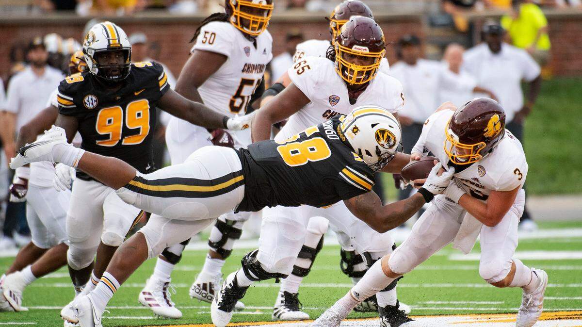 Central Michigan quarterback Jacob Sirmon, right, is sacked by Missouri’s Mekhi Wingo, left, during the fourth quarter of an NCAA college football game Saturday, Sept. 4, 2021, in Columbia, Mo. (AP Photo/L.G. Patterson)