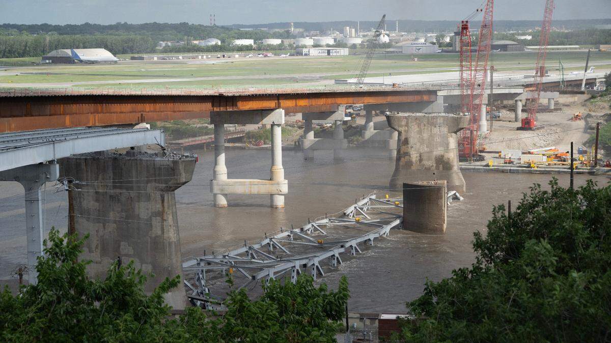 The new flyover ramp that will take northbound I-35 traffic over the Buck O’Neil Bridge to northbound U.S. 169 will open Tuesday afternoon. In this file photo, the debris of the final arch of the Buck O’Neil Bridge rests in the Missouri River after it was taken down with explosive charges earlier this year.