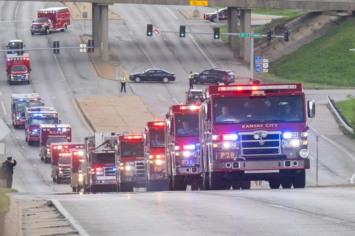 The funeral procession for fallen KCFD firefighter Grant Hoffman passes bystanders on Bannister Road in Kansas City on Friday, May 2, 2025.