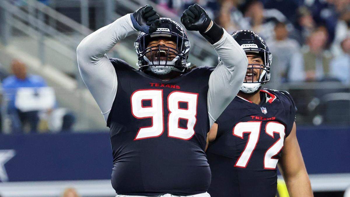 Nov 18, 2024; Arlington, Texas, USA; Houston Texans defensive tackle Tim Settle Jr. (98) reacts after a sack during the second half against the Dallas Cowboys at AT&T Stadium. Mandatory Credit: Kevin Jairaj-Imagn Images