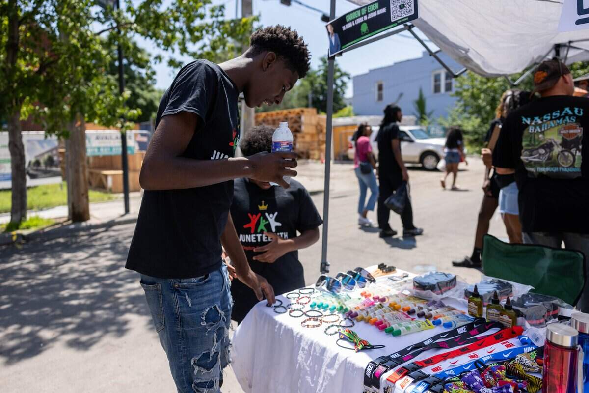 Eden Ashiofu, 15, owner of Garden of Eden, prepares their booth during JuneteenthKC 15th Annual Heritage Festival at E 18th Street on Saturday, June 20, 2026. Ashiofu stared their business of bracelets at six years old. “I didn't just want to go to school and go home. I didn't want to be one of those kids and wanted to do something more,” quoted Ashiofu.