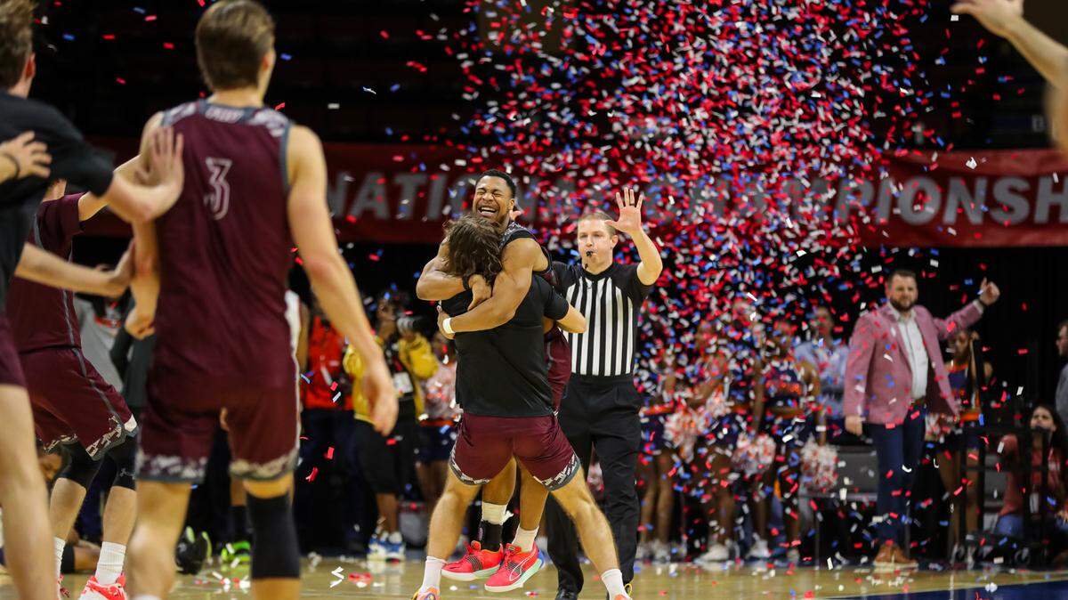 JJ Wheat celebrates with a Freed-Hardeman teammate as the Lions win the NAIA national championship at Municipal Auditorium. FHU overcame a six-point deficit in the final minute to beat Langston University 71-67 on March 26, 2024.