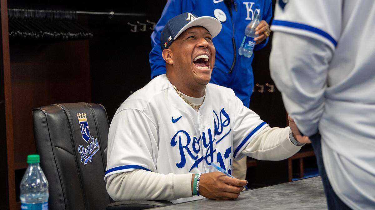 Kansas City Royals catcher Salvador Perez laughs while signing at autographs at the Royals Rally on Saturday, Feb. 3, 2024, at Kauffman Stadium.