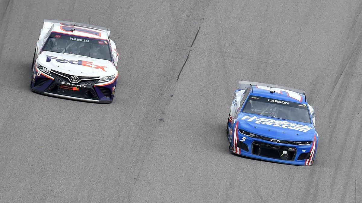 Kyle Larson (5) passes Denny Hamlin (11) in the third stage of the NASCAR Cup Buschy McBusch Race 400 at Kansas Speedway Sunday, May 2, 2021. Kyle Busch won the race.