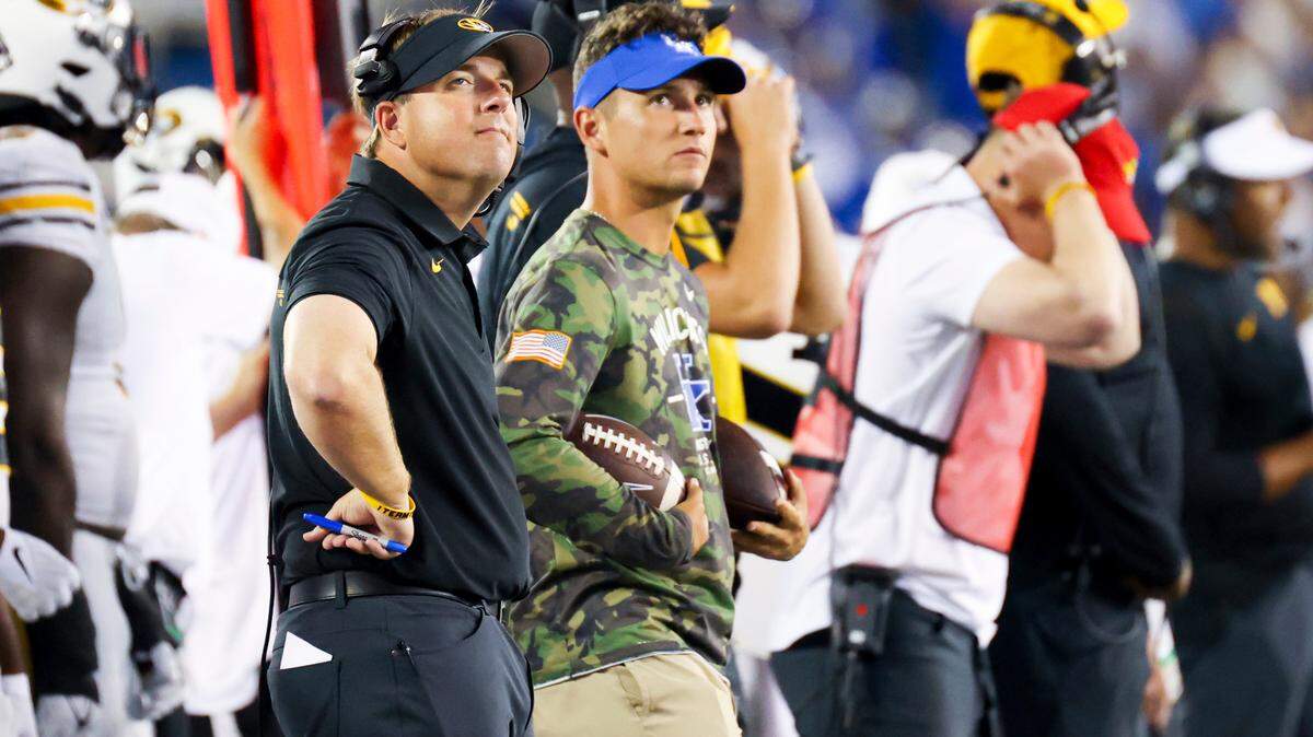 Missouri head coach Eliah Drinkwitz (left) looks up at the video board during a NCAA college football game against Kentucky in Lexington, Ky., Saturday, Sept. 11, 2021. (AP Photo/Michael Clubb)