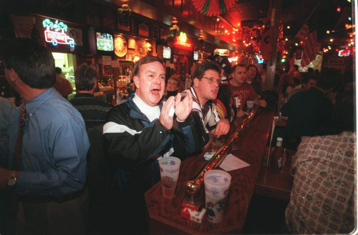 Fans watch the 1997 Super Bowl inside the Tanner’s on 119th Street. The longtime neighborhood hangout will soon close.
