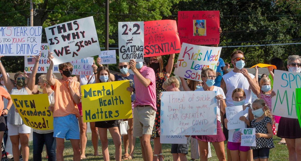 Parents and students protested outside Shawnee Mission’s Center for Academic Achievement last summer, calling for in-person classes and the restart of sports programs.