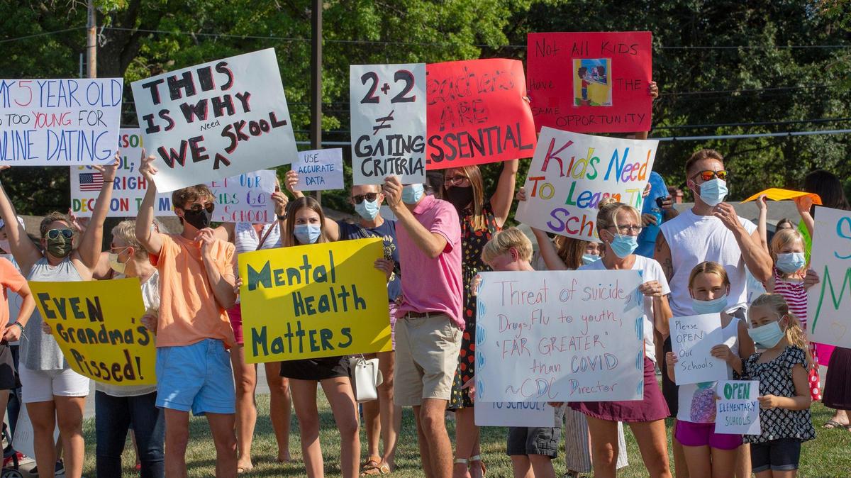 Parents and students protested outside Shawnee Mission’s Center for Academic Achievement, in Overland Park last month, calling for in-person classes and the restart of sports. The protests resumed at Wednesday’s school board meeting.