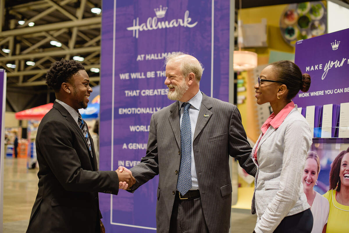 Hallmark president Dave Hall meets students at the Enactus Expo career fair at Bartle Hall.