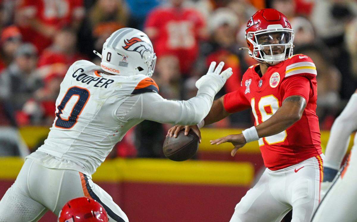Kansas City Chiefs quarterback Chris Oladokun (19) attempts to throw a pass while being challenged by Denver Broncos linebacker Jonathon Cooper (0) in the first half of the game at GEHA Field at Arrowhead Stadium on Thursday, Dec. 25, 2025.