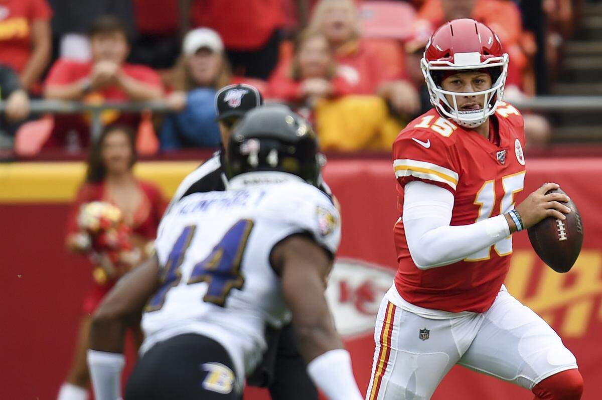 Chiefs quarterback Patrick Mahomes scrambles with the ball during the first half of game action at the home opener Sunday, September 22, 2019, at Arrowhead Stadium.