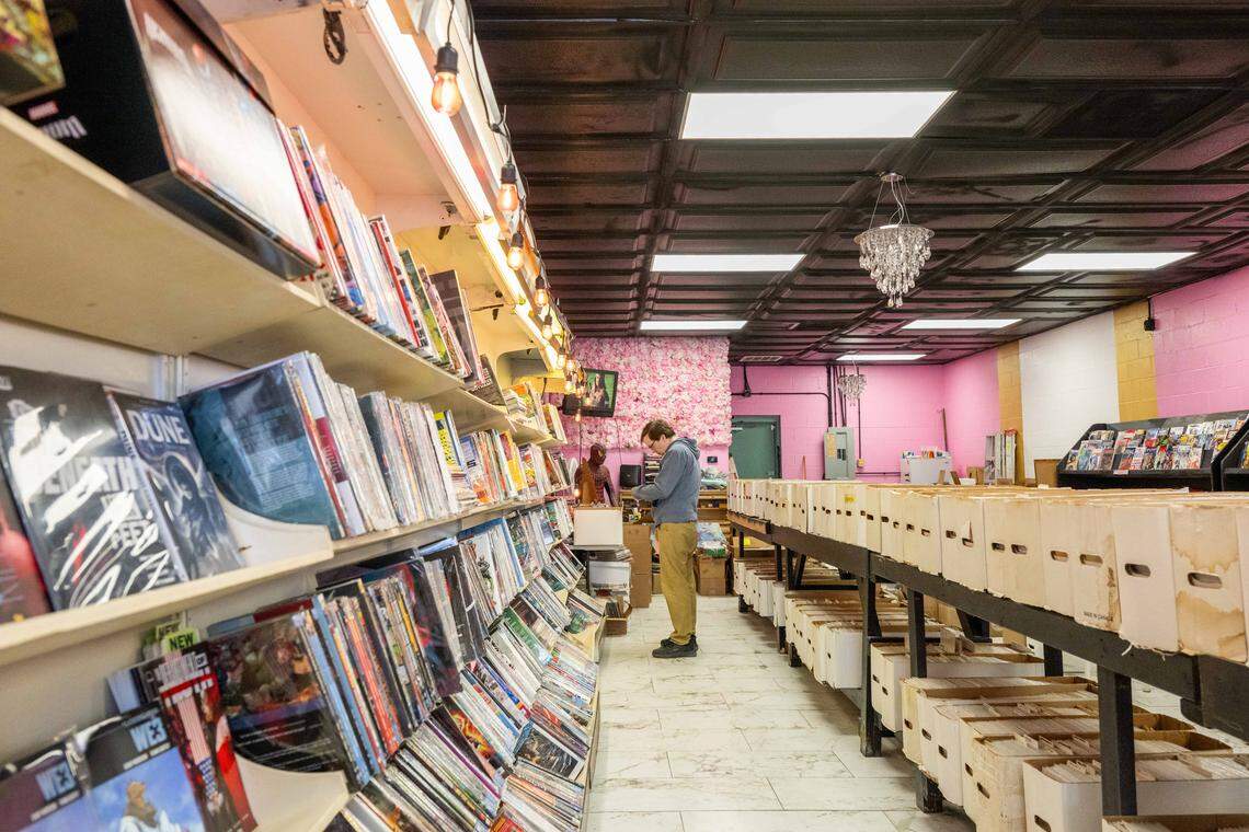 A customer browses for comics at the new location of Clint's Comics in Independence on Tuesday, January 7, 2026. Clint's Comics was previously located in Midtown Kansas City before the ceiling collapsed on the building it occupied.
