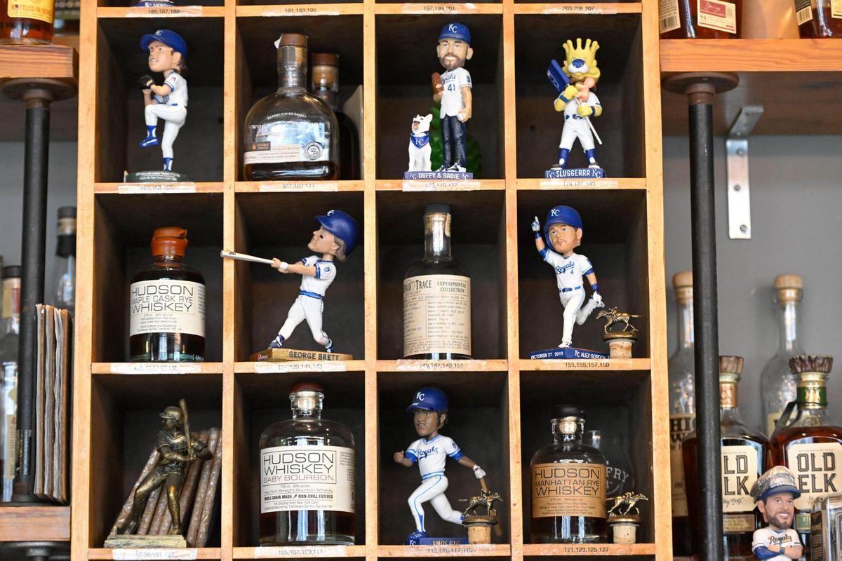 Belfry owner Celina Tio loves baseball and displays some of her bobblehead collection behind the bar.