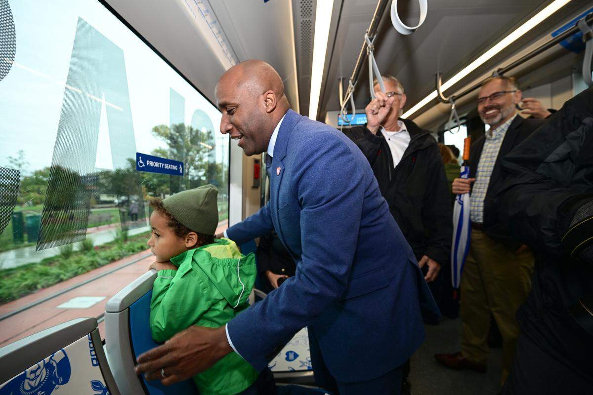 Kansas City Mayor Quinton Lucas takes a ride along the new KC Streetcar extension route with his son Bennett on Friday, Oct. 24, 2025, during the grand opening celebration for the KC Streetcar extension in Kansas City.