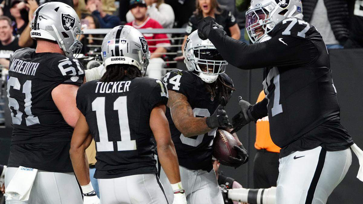 Las Vegas Raiders running back Brandon Bolden (34) celebrates with teammates after scoring a touchdown in the second quarter against the Los Angeles Chargers at Allegiant Stadium.