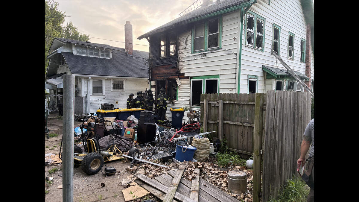 Kansas City firefighters battled a fire at a two-story house in the 3300 block of Bales Avenue early Tuesday. Two people were rescued from the roof, and no injuries were reported, a Kansas City Fire Department spokesman said.