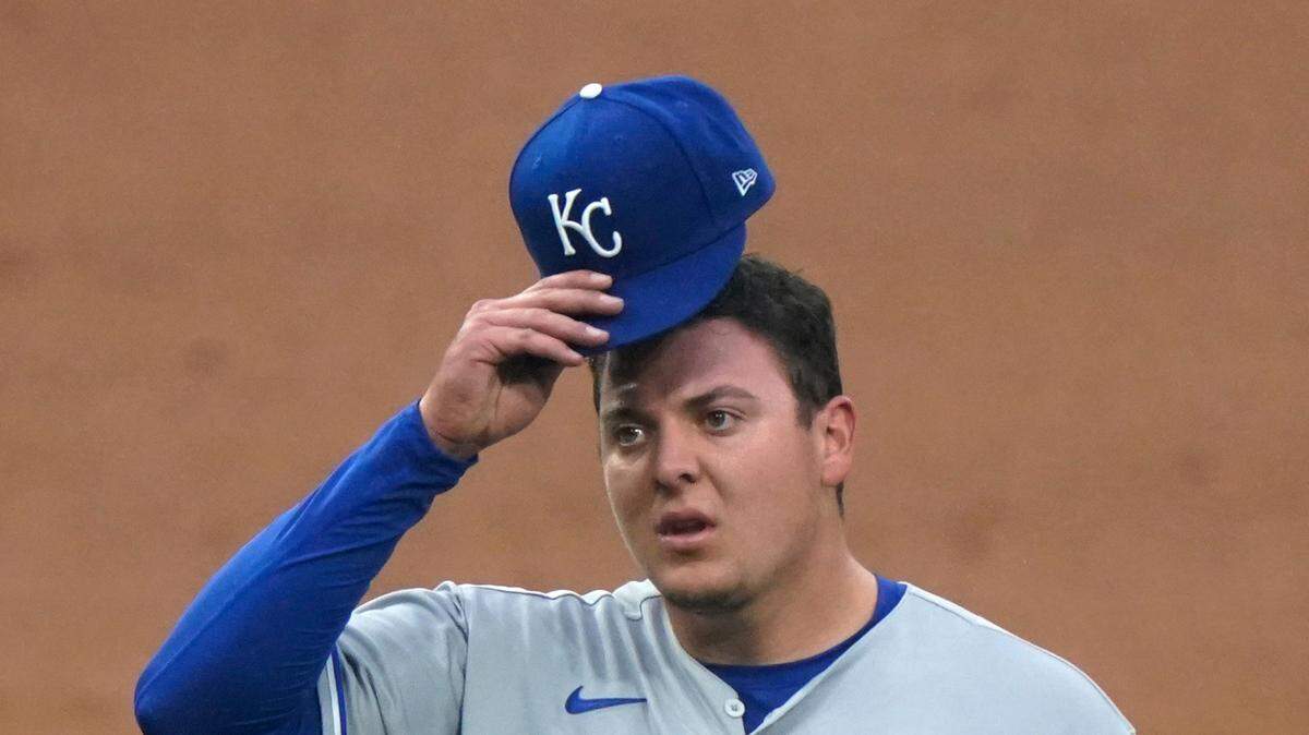 Kansas City Royals starting pitcher Brad Keller adjusts his cap during the first inning of the team’s baseball game against the Chicago White Sox in Chicago, Thursday, April 8, 2021.