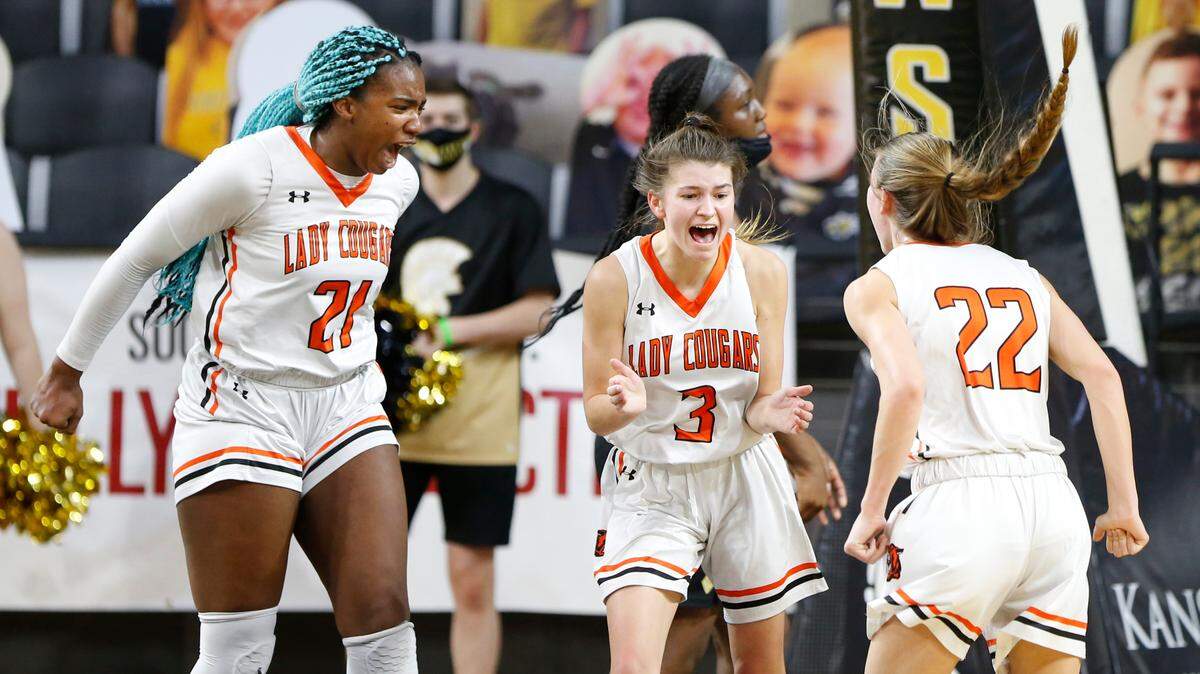 Shawnee Mission Northwest’s Saige Grampsas (center) celebrates another bucket on Saturday during the Kansas Class 6A state championship against Topeka. Grampsas had 26 points on the night.