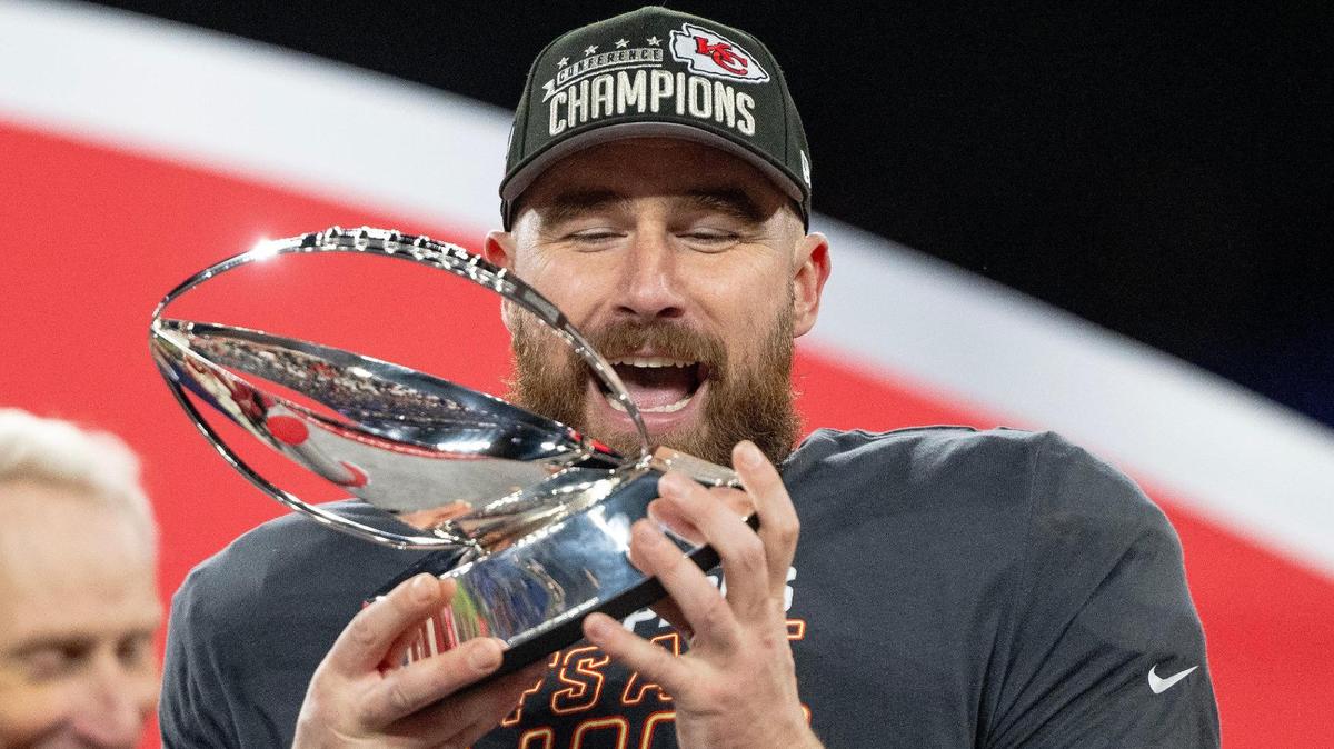 Kansas City Chiefs tight end Travis Kelce (87) celebrates with the Lamar Hunt Trophy after the Chiefs defeated the Baltimore Ravens 17-10 in the AFC Championship Game on Sunday, Jan. 28, 2024, in Baltimore.