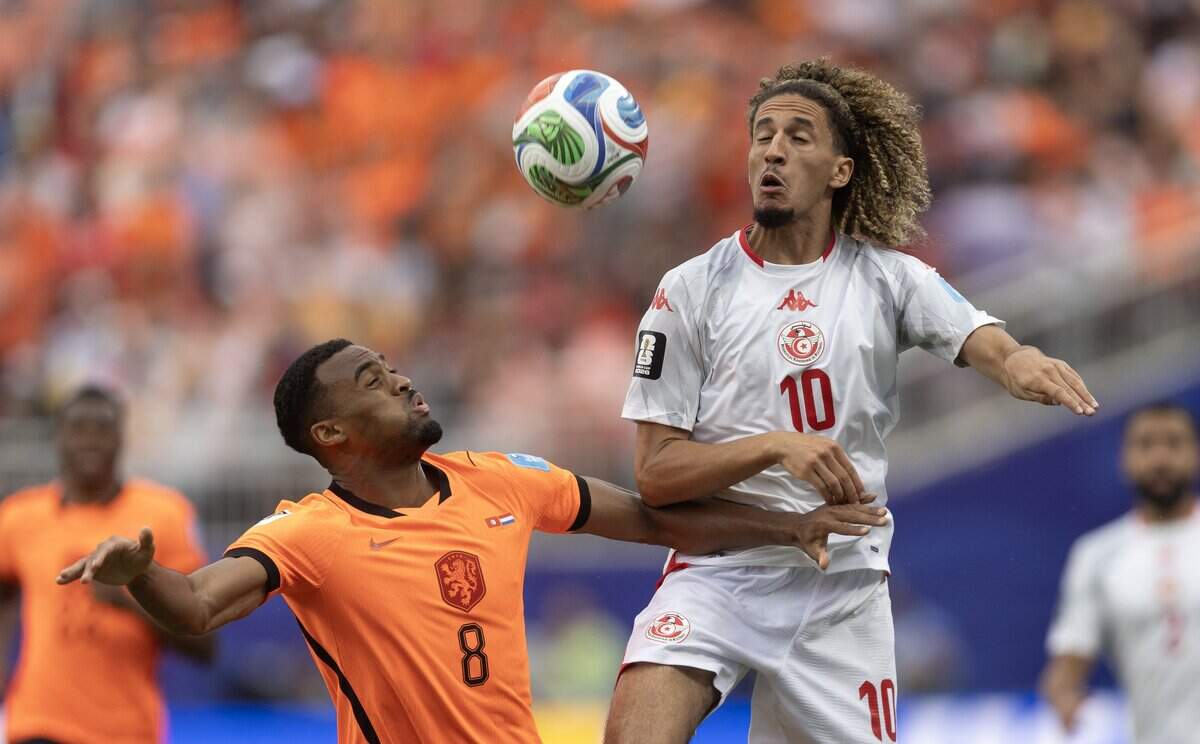 Tunisia midfielder Hannibal Mejbri (10) tries to keep the ball away from Netherlands midfielder Ryan Gravenberch (8) during a FIFA World Cup group-stage soccer match at Kansas City (Arrowhead) Stadium in Kansas City on Thursday, June 25, 2026.
