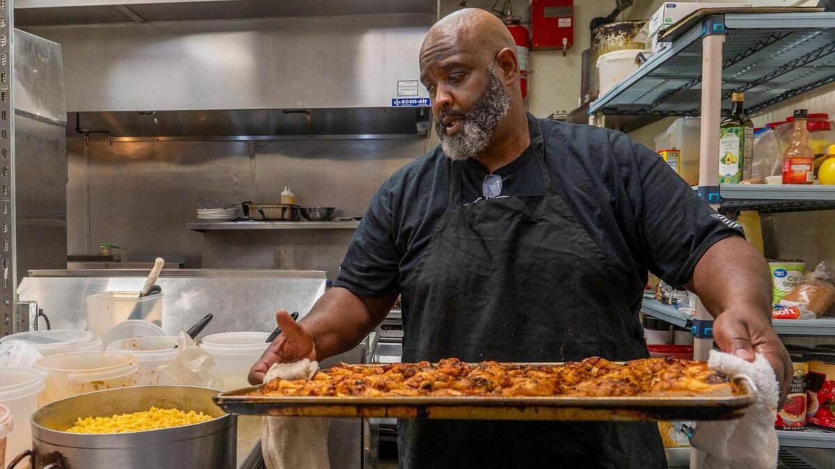 Lutfi Khalifa, owner of Lutfi’s Fried Fish, carries a tray of freshly baked chicken that will go into a smoker at his Lee’s Summit restaurant. Khalifa is a Muslim and is currently navigating the daily fasting of Ramadan while working in the food industry.