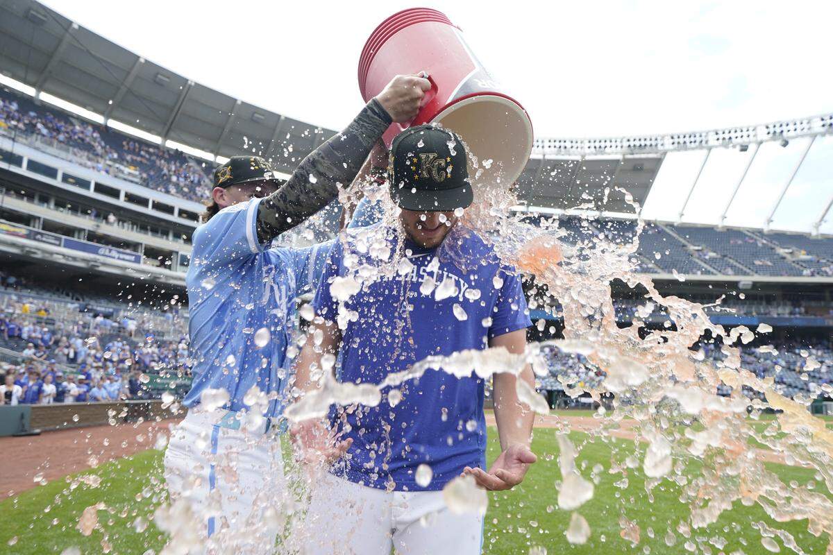 Vinnie Pasquantino #9 of the Kansas City Royals is doused with water by Bobby Witt Jr. #7 of the Kansas City Royals after an 8-4 win over the Athletics at Kauffman Stadium on May 19, 2024 in Kansas City.