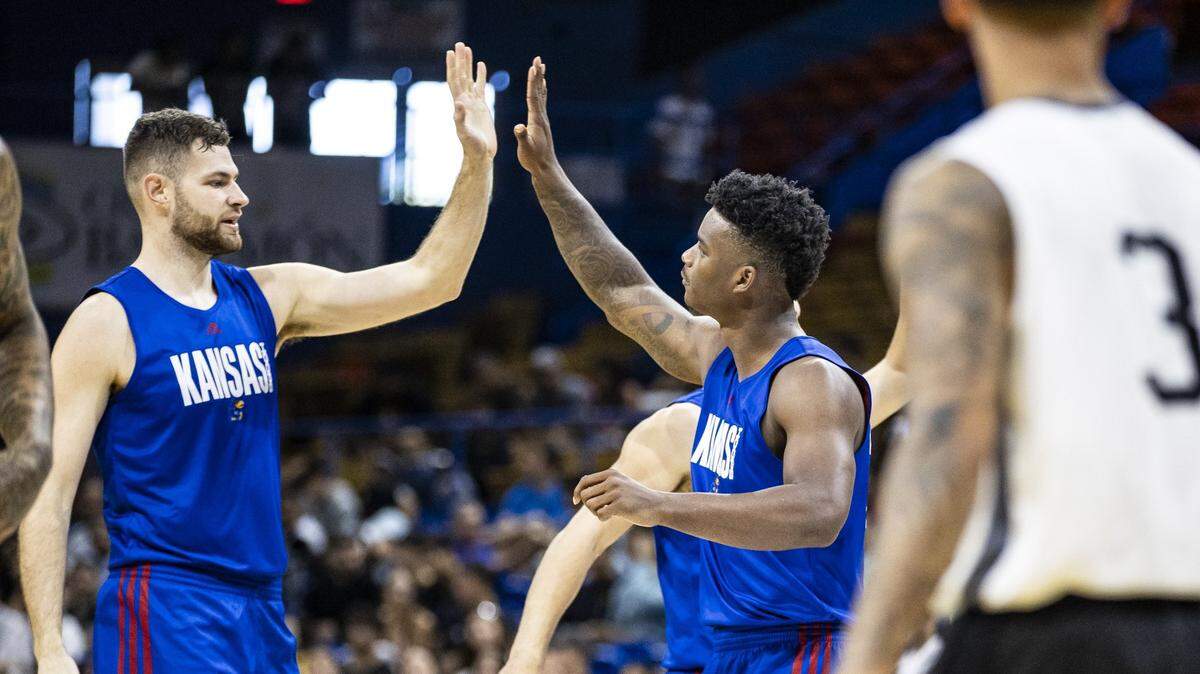 Hunter Dickinson, left, exchanges a high-five with Kansas Jayhawks teammate KJ Adams during Thursday’s men’s basketball exhibition game against Puerto Rico Select at Ruben Rodriguez Coliseum in San Juan, Puerto Rico.