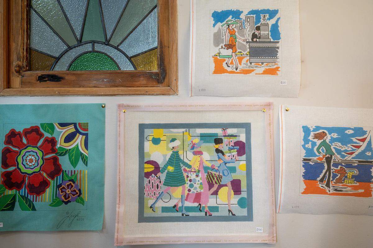 Needlepoint canvases displayed for sale at The Parkville Needlepoint House on Wednesday, Feb. 11, 2026, in Parkville.