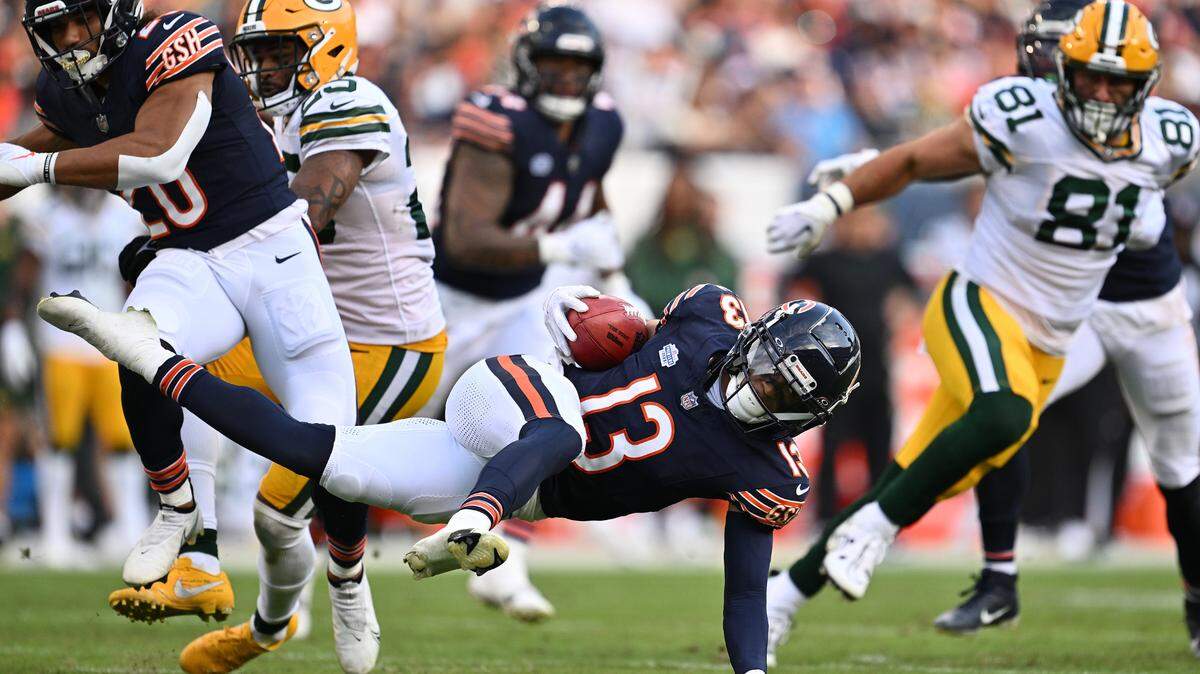 Chicago Bears wide receiver Tyler Scott (13) is tripped up after a kickoff return in the second half against the Green Bay Packers at Soldier Field.