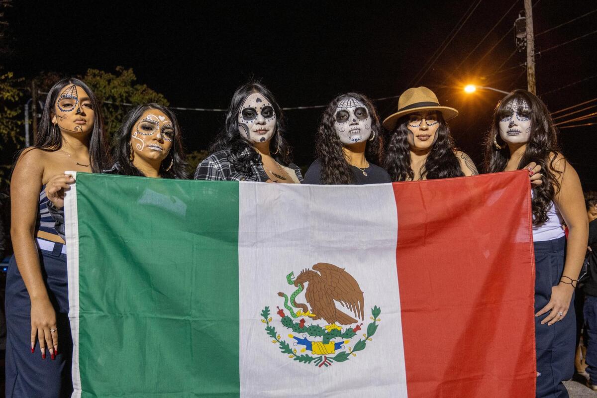 Delicia Velo, left, Zenaida Estrada, Yulissa Lopez, Ariana Perez, Mia Rodriguez-Quintana, and Jessie Garcia pose for photos dressed as Catrinas after completing their participation in the Dia de los Muertos festival parade at the Mattie Rhodes Center on Friday, Nov. 3, 2023, in Kansas City.