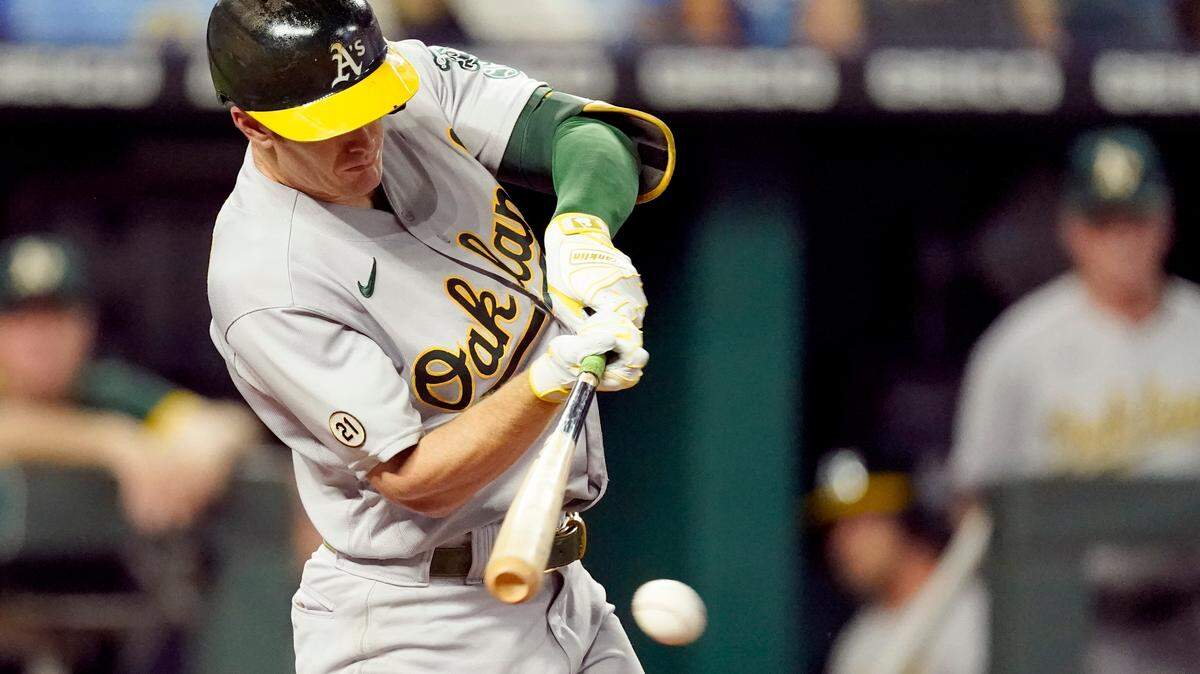 Oakland Athletics’ Mark Canha hits an RBI single during the third inning of a baseball game against the Kansas City Royals Wednesday, Sept. 15, 2021, in Kansas City, Mo. (AP Photo/Charlie Riedel)