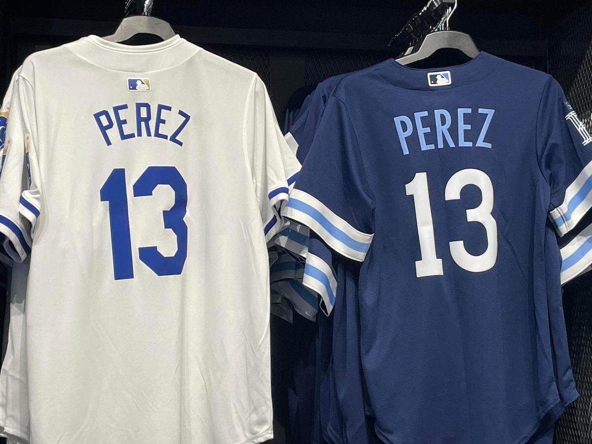 The new lettering is on the left of a Salvador Perez jersey. The old is on the right.