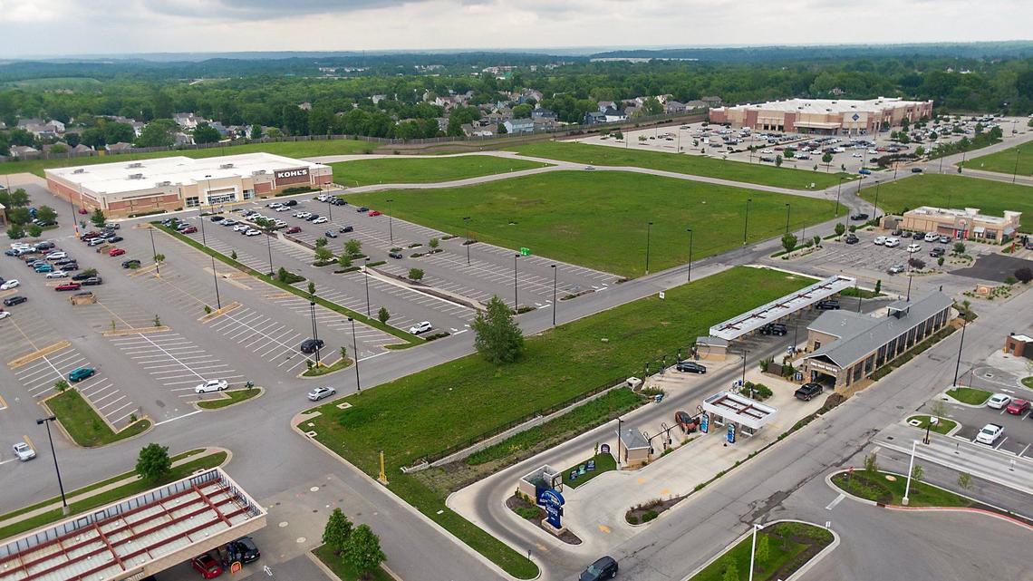 Parcels of vacant land for sale sit near the Kohl’s, left, and Sam’s Club on Parallel Parkway, within the Plaza at the Speedway shopping center, on Tuesday, May 14, 2024, in Kansas City, Kansas. The parcels are classified as hay farms because of a vague Kansas law and is allowing owners to save on property taxes.