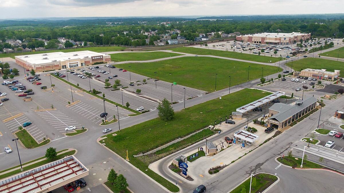 Parcels of vacant land for sale sit near the Kohl’s, left, and Sam’s Club on Parallel Parkway, within the Plaza at the Speedway shopping center, on Tuesday, May 14, 2024, in Kansas City, Kansas. The parcels are classified as hay farms because of a vague Kansas law and is allowing owners to save on property taxes.