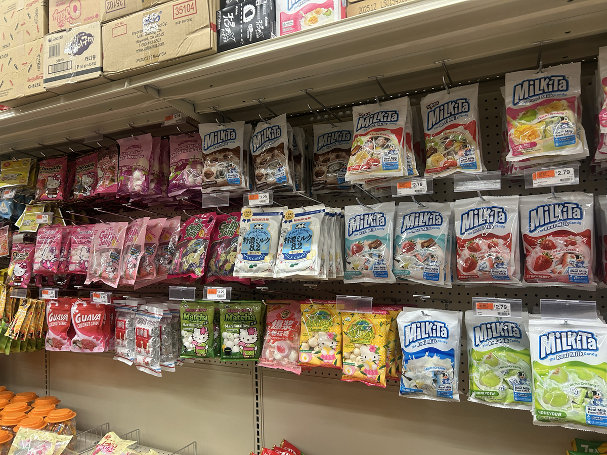 The grocery store is stocked with a variety of Asian snacks, along with fruity and chocolate candies.