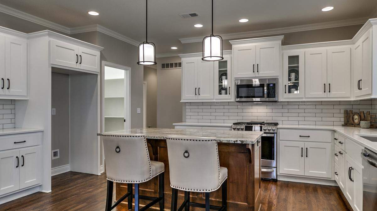 The Ensley II plan offers a gourmet kitchen with luxurious finishes and plenty of room to prepare meals and entertain guests.