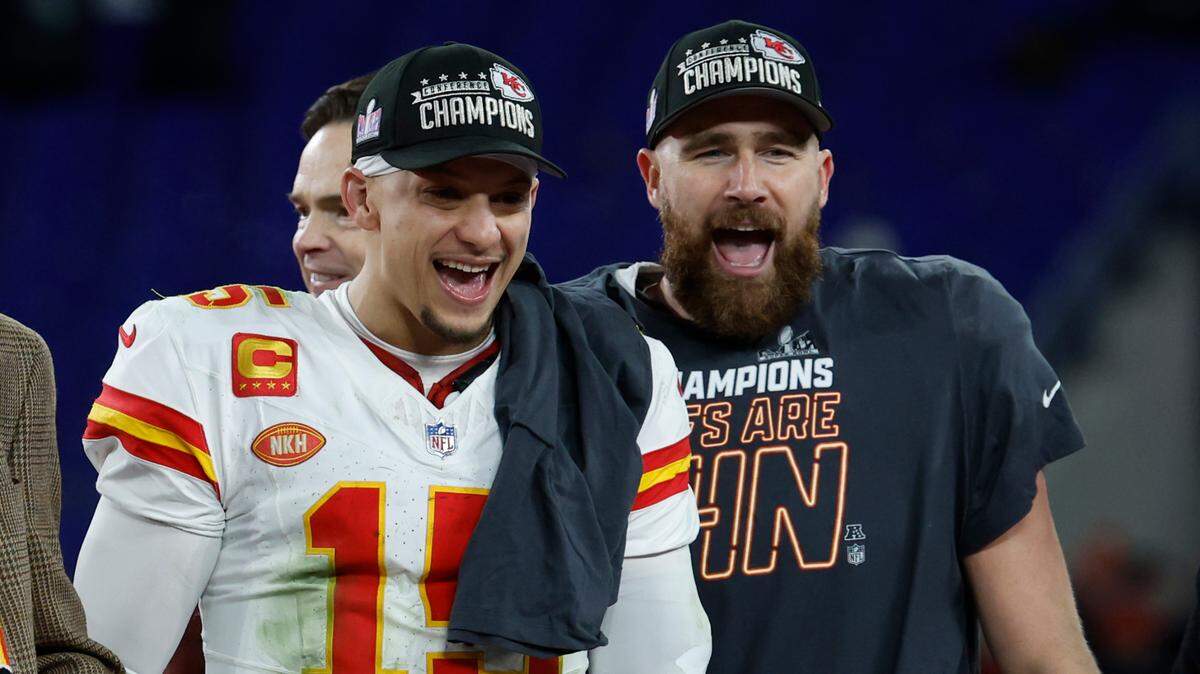 Kansas City Chiefs quarterback Patrick Mahomes (left) and tight end Travis Kelce celebrate on the stage prior to the trophy presentation after their win over the Baltimore Ravens in the AFC Championship Game at M&T Bank Stadium on Jan. 28, 2024.