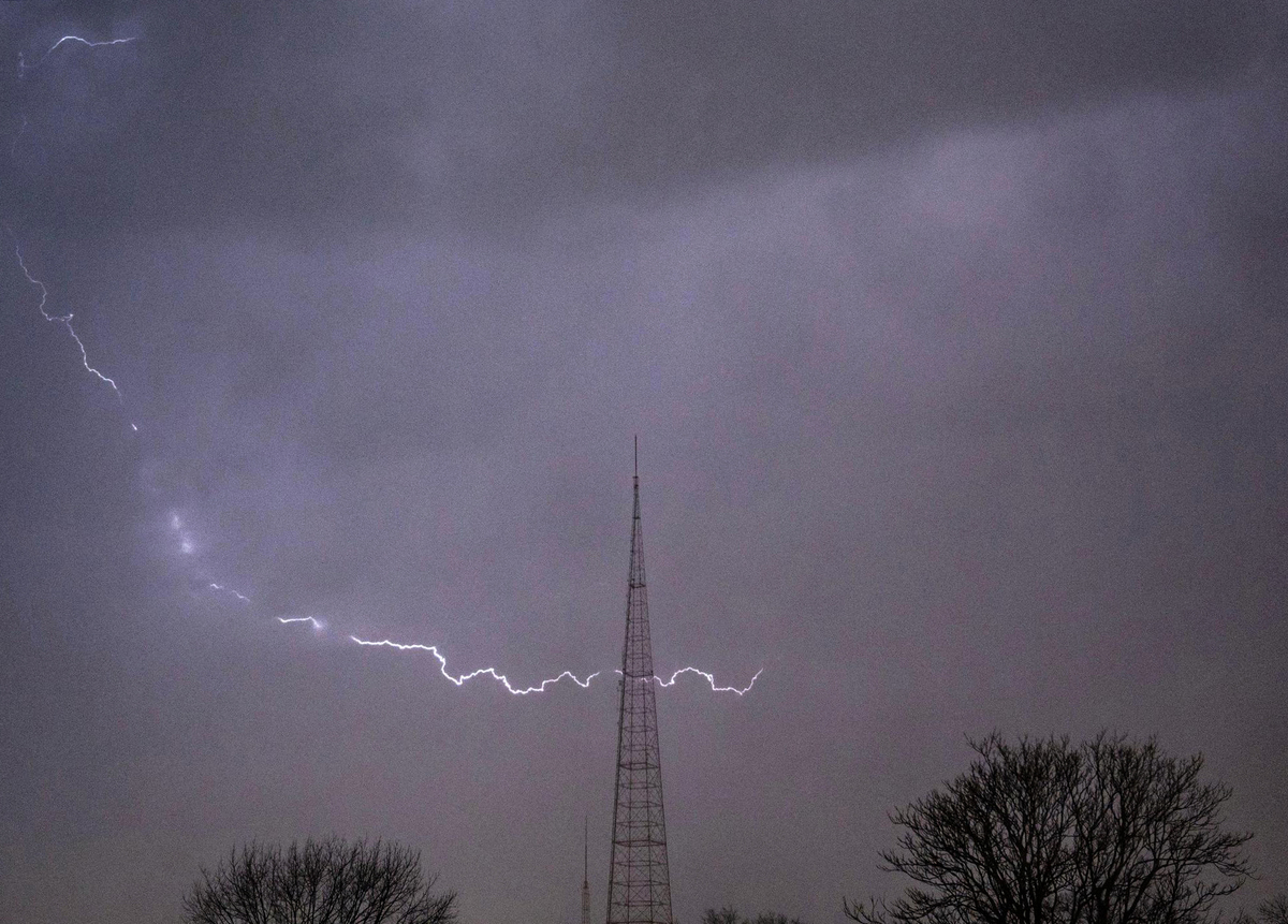 A bolt of lighting arcs across the sky over mid-town Kansas City on Wednesday, March 13, 2024, in Kansas City.